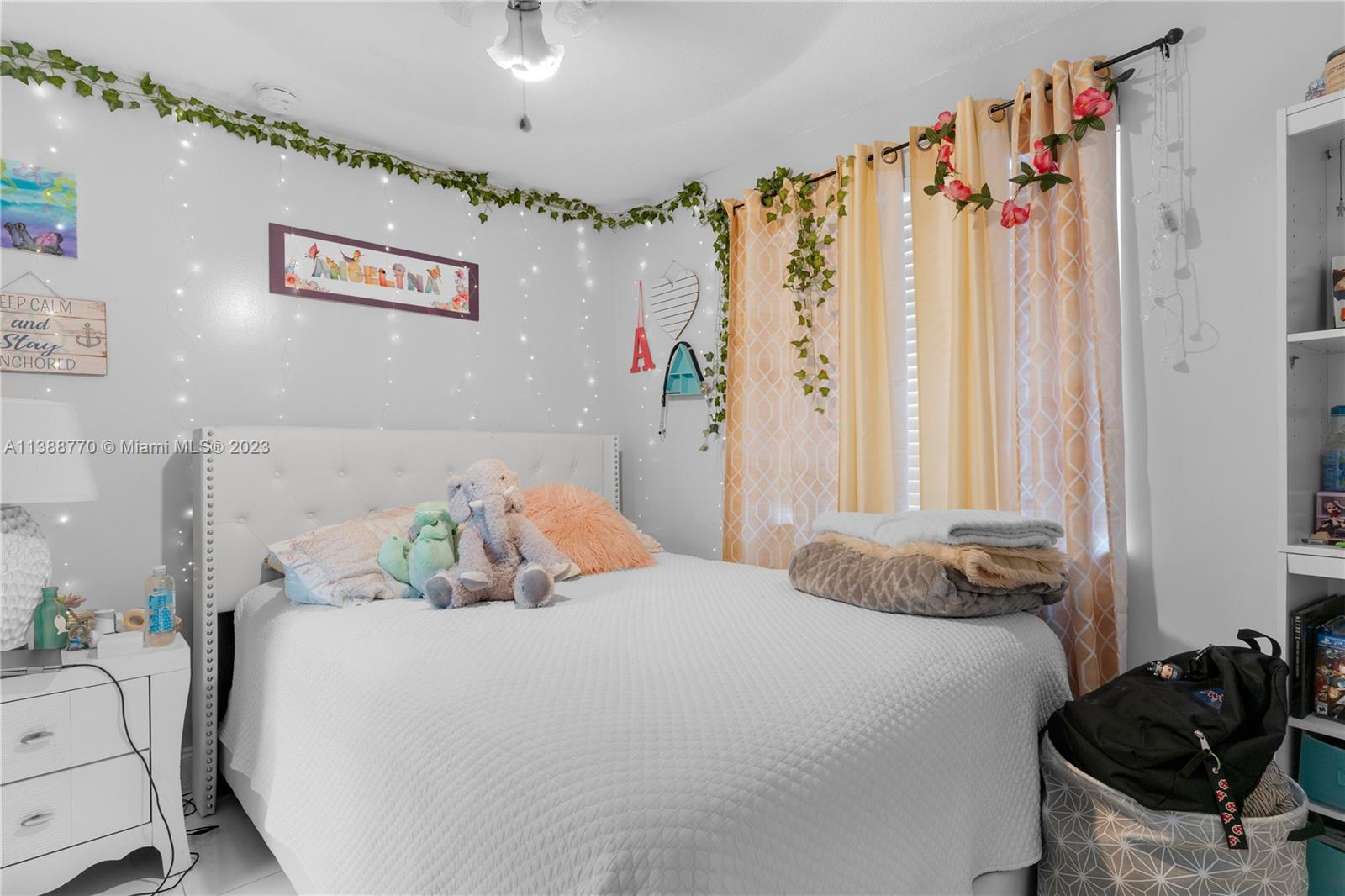 12458 Southwest 220th Street Miami, FL 33170 - Photo 15 of 25 a bedroom with a bed and a window