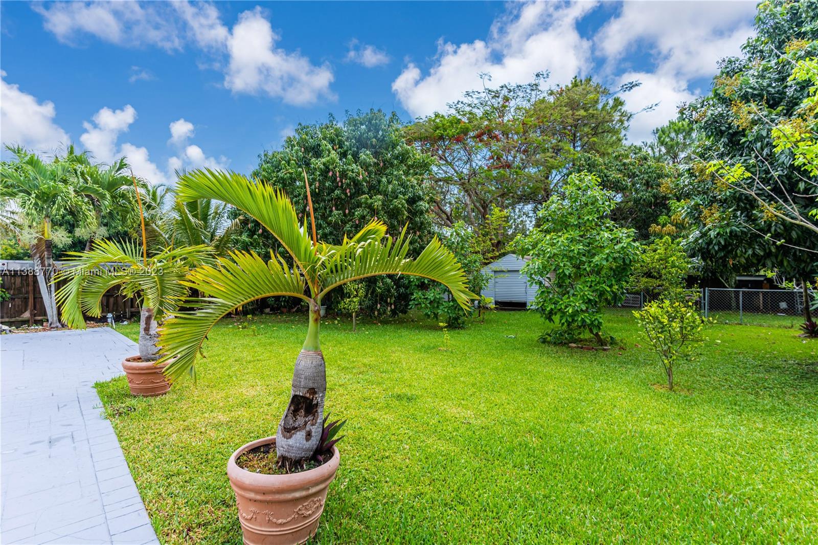 12458 Southwest 220th Street Miami, FL 33170 - Photo 19 of 25 a garden view with a seating space