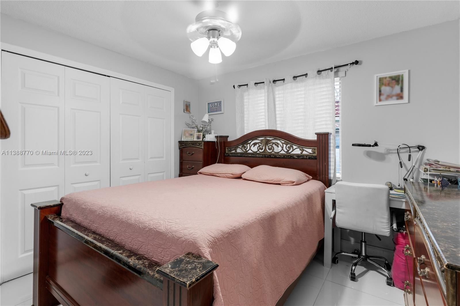 12458 Southwest 220th Street Miami, FL 33170 - Photo 20 of 25 a bedroom with a bed and a chandelier