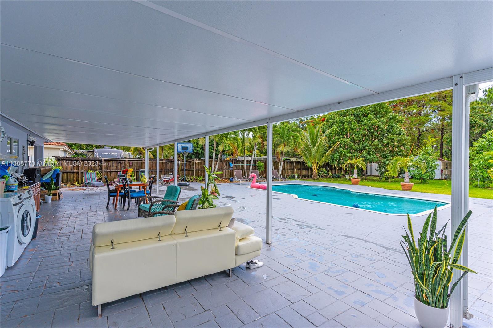 12458 Southwest 220th Street Miami, FL 33170 - Photo 22 of 25 a living room with patio area and garden view
