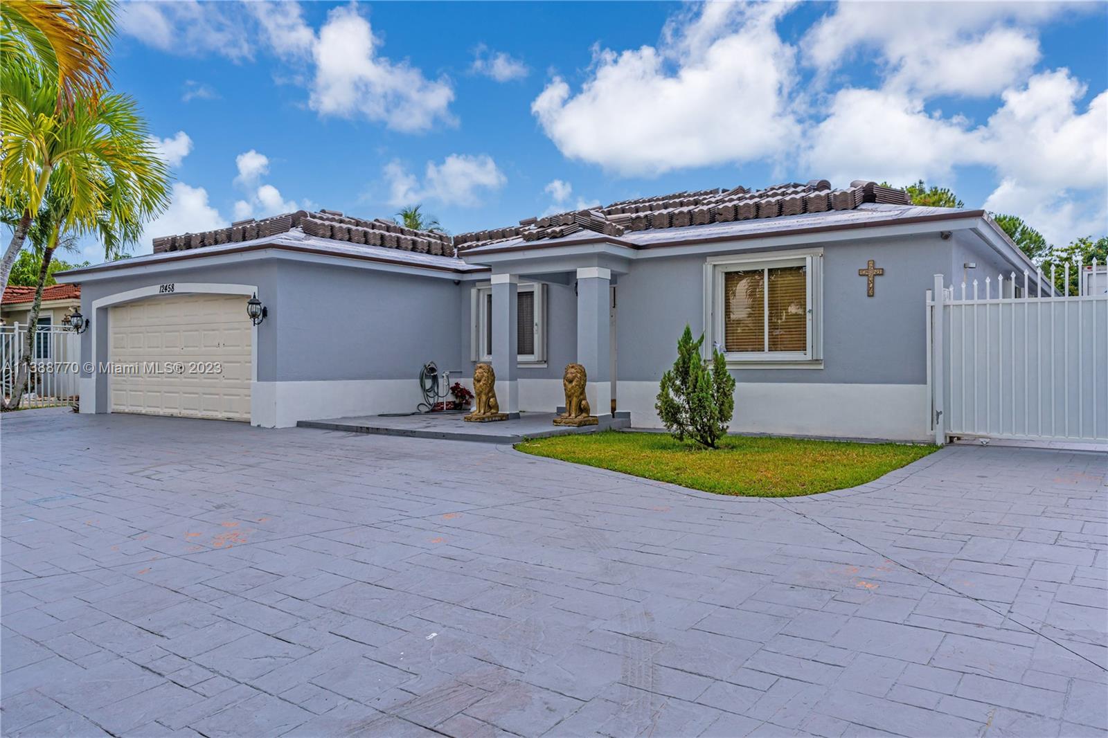 12458 Southwest 220th Street Miami, FL 33170 - Photo 4 of 25 a view of a house with a backyard and a garage