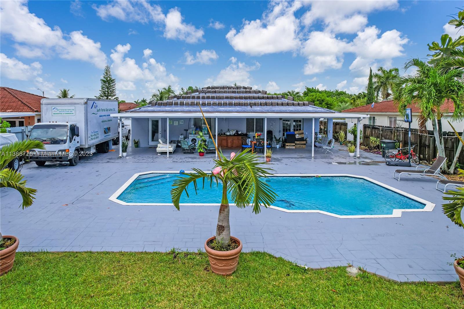 12458 Southwest 220th Street Miami, FL 33170 - Photo 6 of 25 a swimming pool with outdoor seating and yard