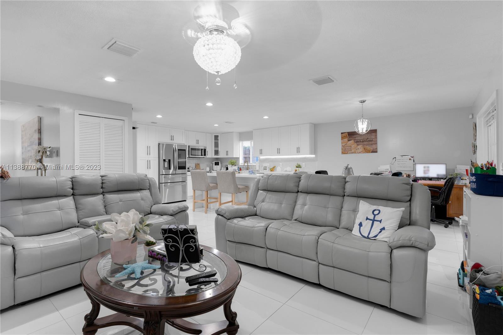 12458 Southwest 220th Street Miami, FL 33170 - Photo 8 of 25 a living room with furniture kitchen view and a dining table