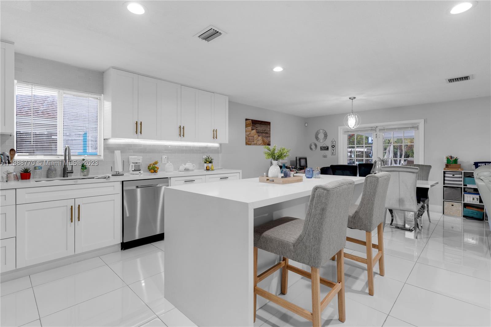 12458 Southwest 220th Street Miami, FL 33170 - Photo 10 of 25 a kitchen with cabinets a sink stainless steel appliances and window