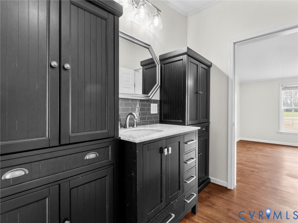 4772 Carsley Road Waverly, VA 23890 - Photo 17 of 38 Bathroom with vanity, ornamental molding, dark woo