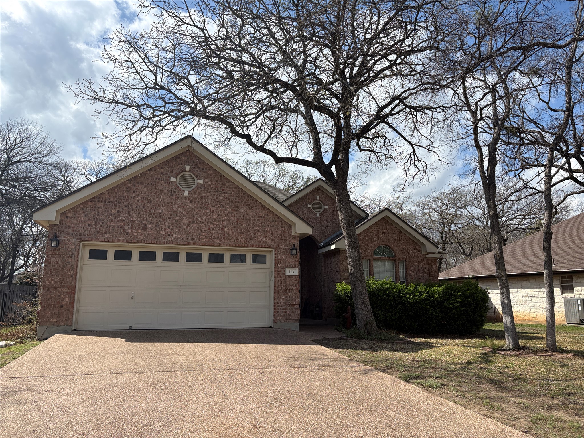 113 Canyon Road Georgetown, TX 78628 - Photo 1 of 21 a front view of a house with a yard and garage