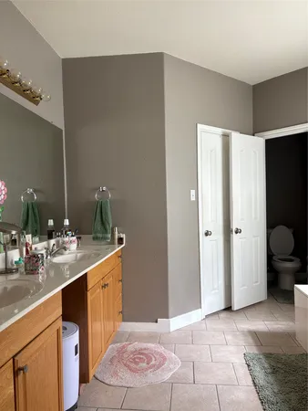 a spacious bathroom with a sink and a mirror