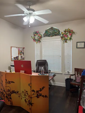 a work room with furniture and flower vase