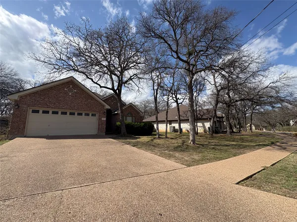 a house that has a tree in front of it
