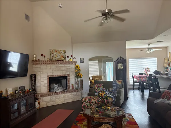 a living room with furniture a flat screen tv and a fireplace