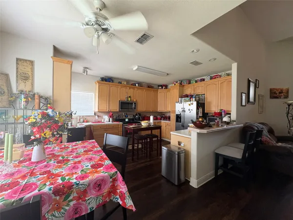 a kitchen with kitchen island a sink stove and white cabinets with wooden floor