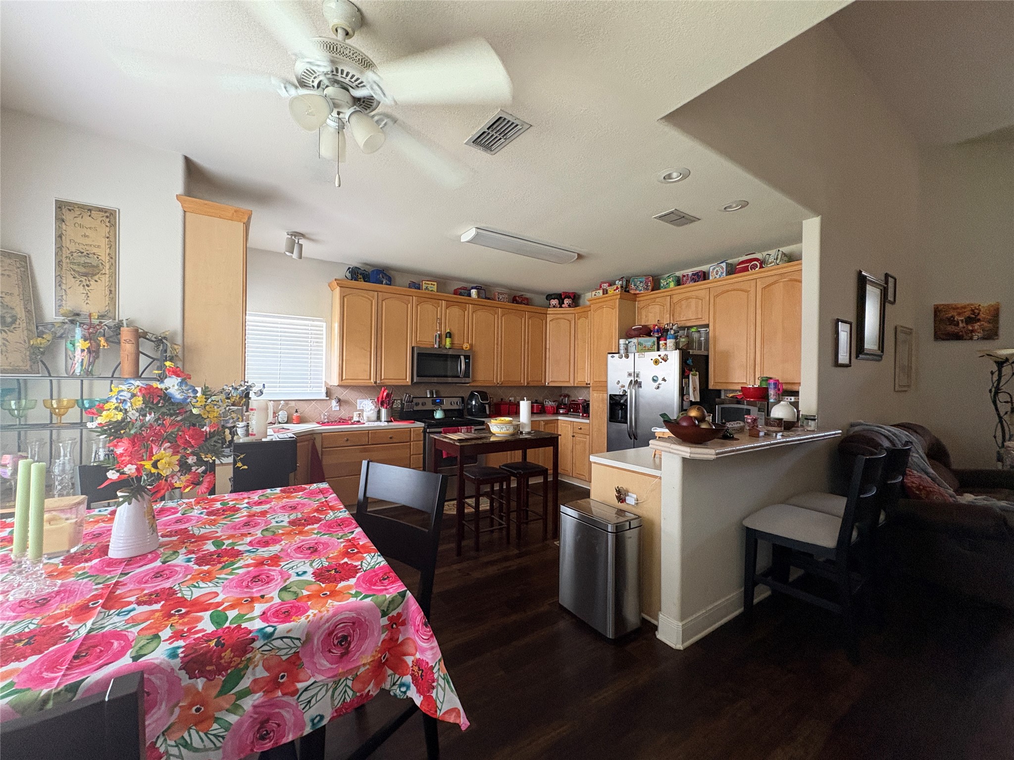 113 Canyon Road Georgetown, TX 78628 - Photo 7 of 21 a kitchen with kitchen island a sink stove and white cabinets with wooden floor