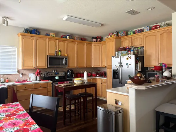 a kitchen with a sink appliances and cabinets
