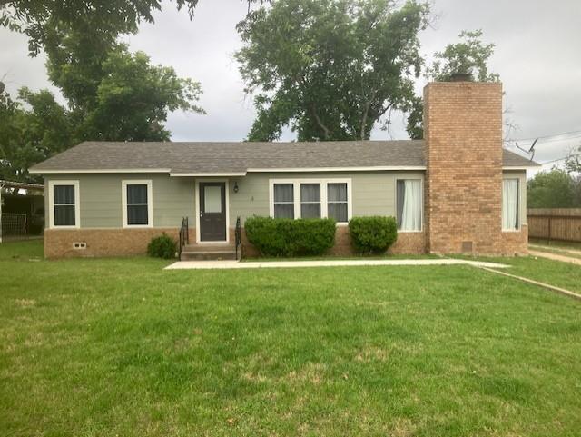 a view of a house with a yard and potted plants
