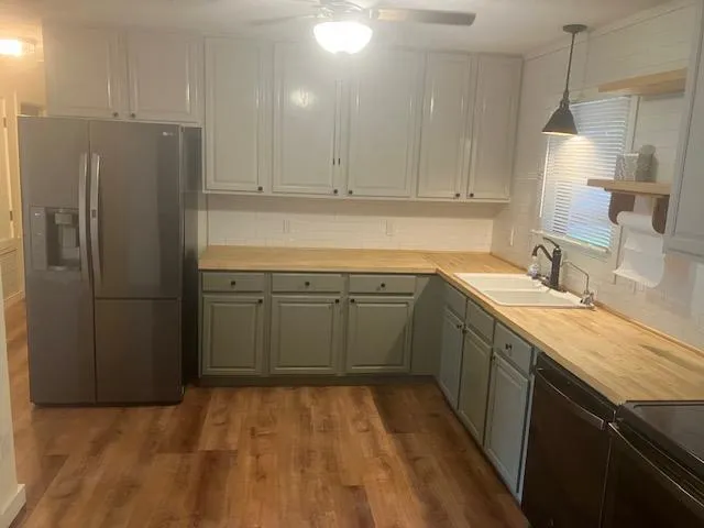a kitchen with a sink appliances and cabinets