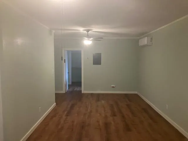 a view of a room with wooden floor and white walls