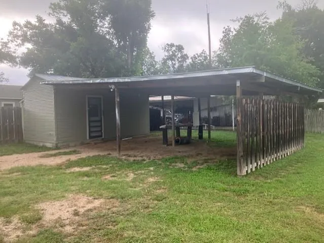 a view of a house with backyard porch and sitting area
