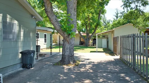 a front view of house with small yard and wooden fence