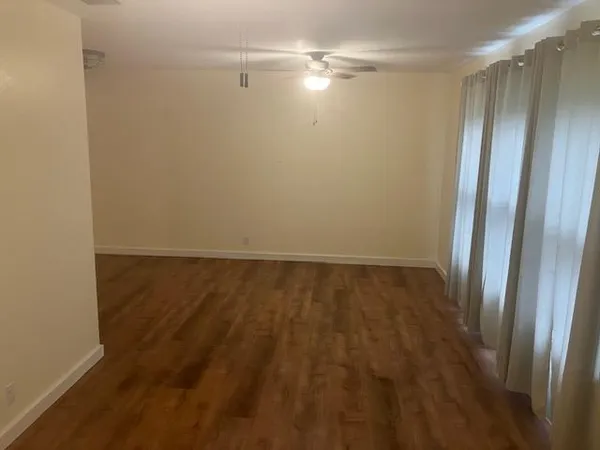 a view of empty room with floor to ceiling window