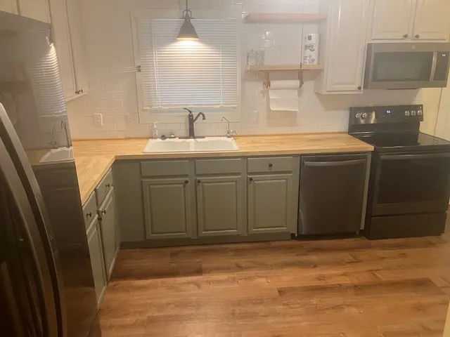 a bathroom with a sink a mirror and a shower