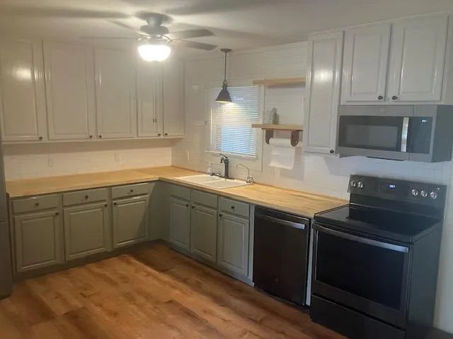 a kitchen with a sink stove and microwave