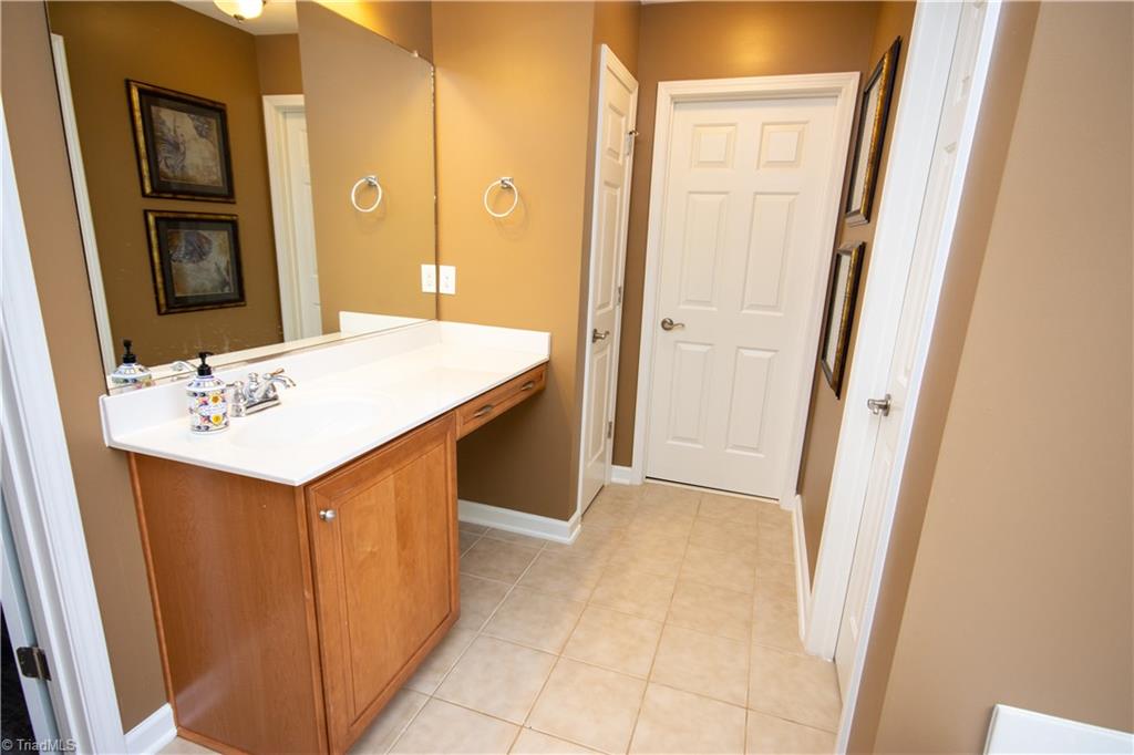 4608 River Valley Road High Point, NC 27265 - Photo 16 of 28 Her sink in master bath. Large walk in closet is conveniently located off the master bath.