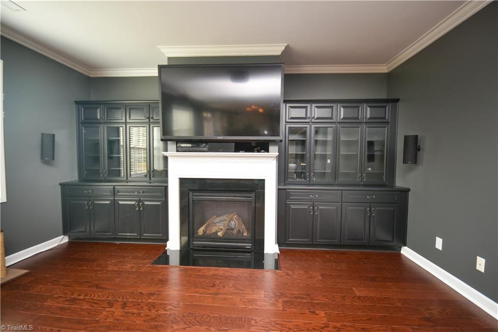 4608 River Valley Road High Point, NC 27265 - Photo 8 of 28 Built in cabinetry surrounds the gas logs fireplace.