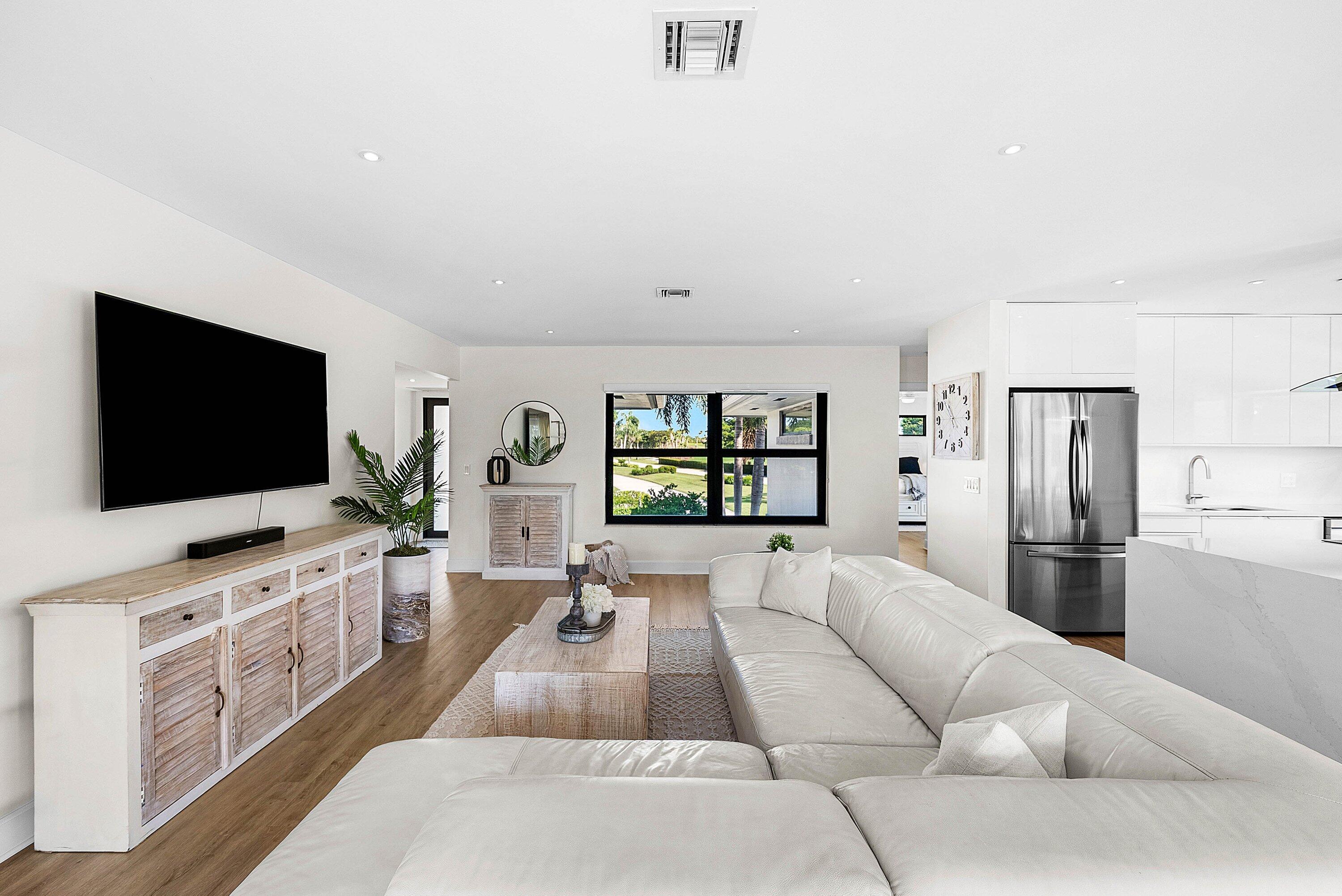 10301 Quail Covey Road, Unit HIBISCUS S Boynton Beach, FL 33436 - Photo 19 of 55 a living room with furniture and a flat screen tv