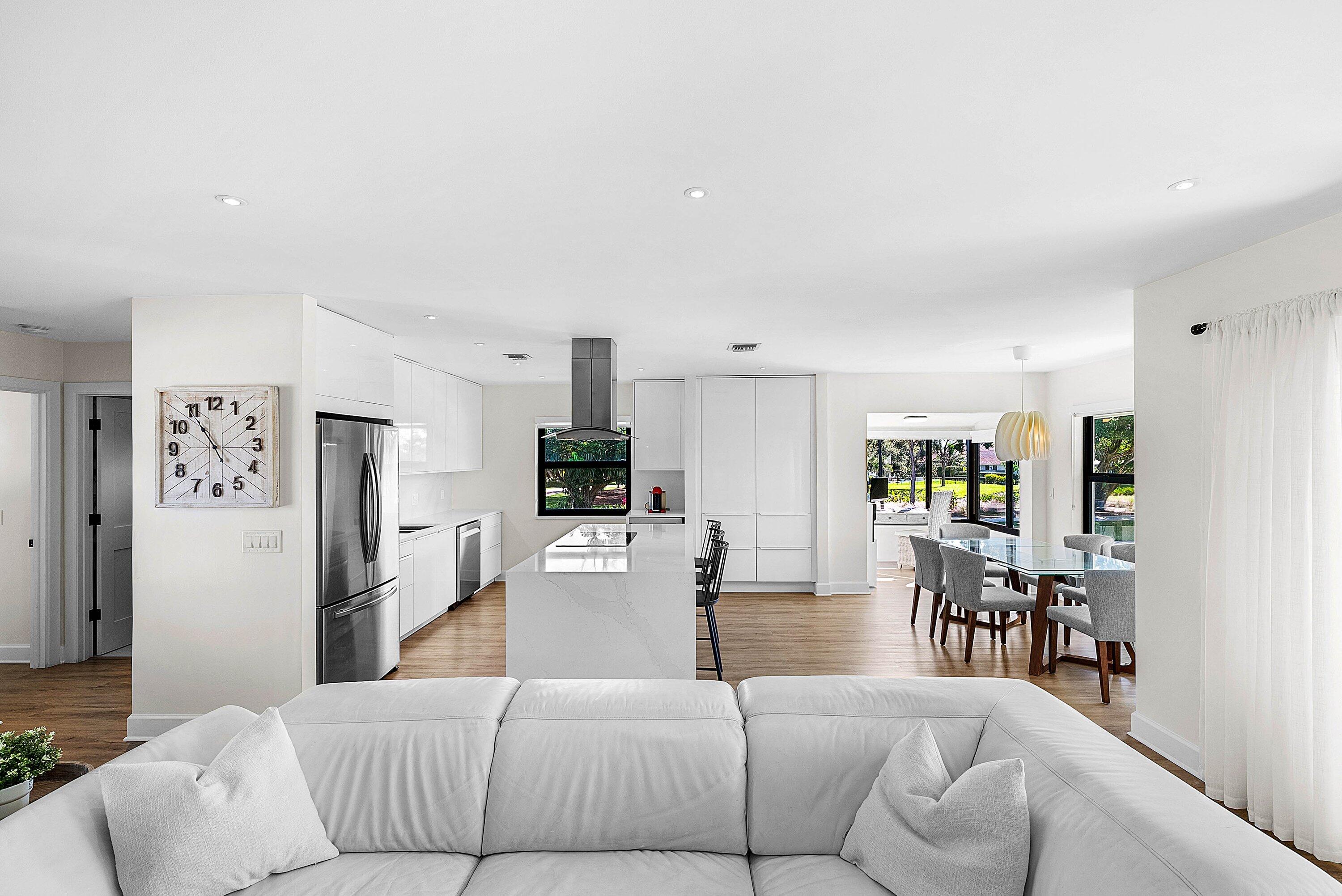 10301 Quail Covey Road, Unit HIBISCUS S Boynton Beach, FL 33436 - Photo 20 of 55 a living room with furniture a large window and kitchen view