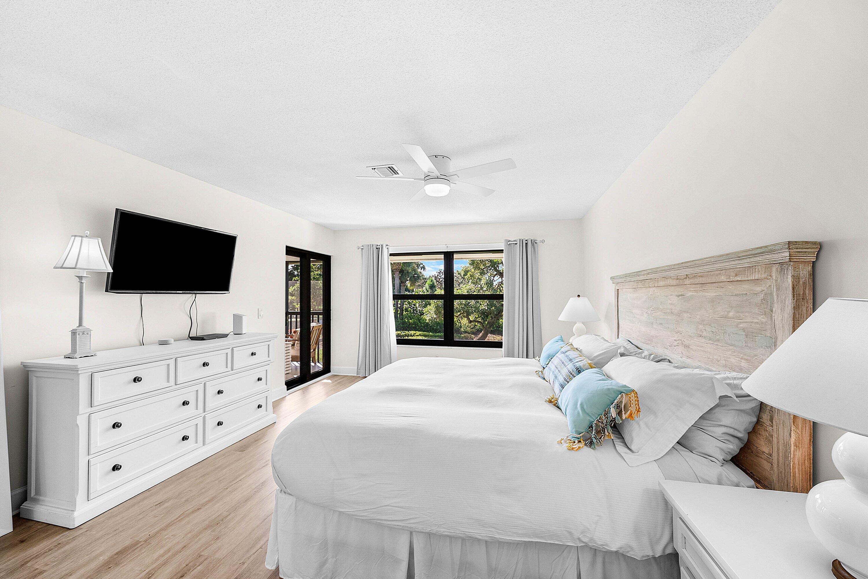 10301 Quail Covey Road, Unit HIBISCUS S Boynton Beach, FL 33436 - Photo 24 of 55 a spacious bedroom with a bed and a flat screen tv