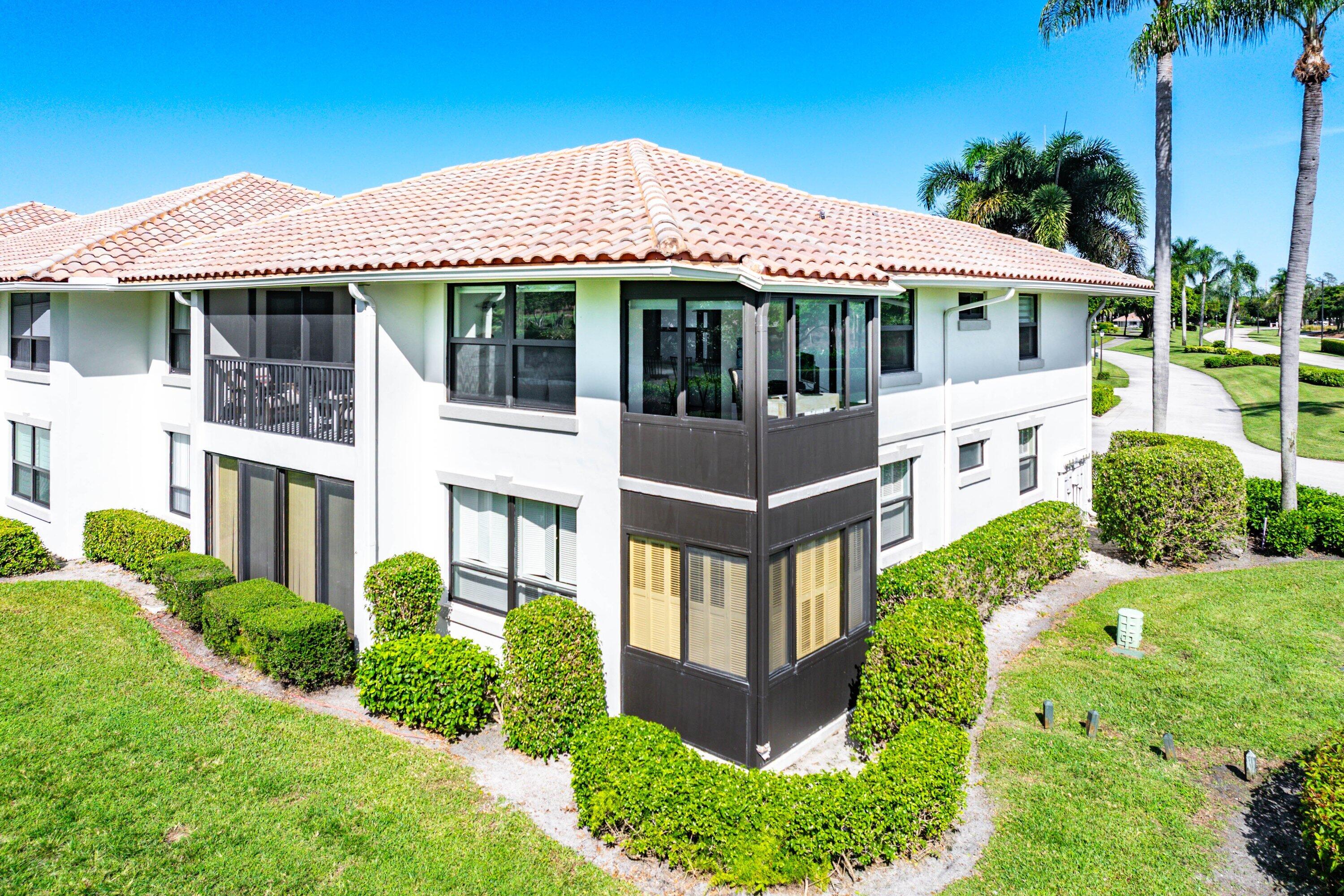 10301 Quail Covey Road, Unit HIBISCUS S Boynton Beach, FL 33436 - Photo 35 of 55 a front view of a house with garden