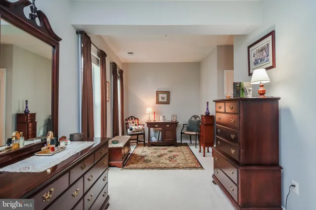 a bathroom with a tub a sink and a large mirror