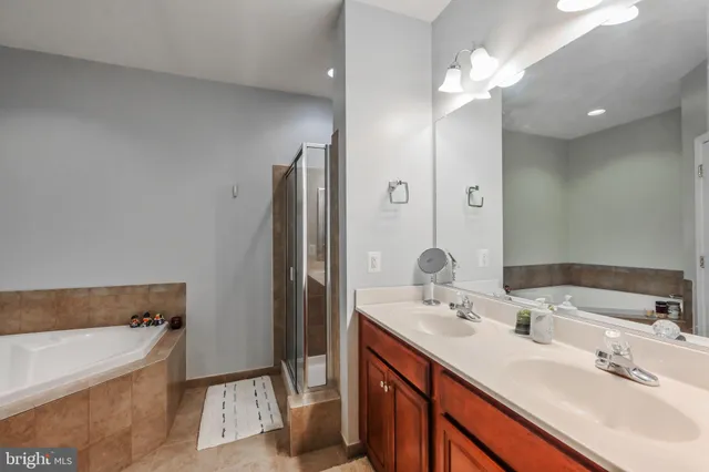 a bathroom with a double vanity sink and a mirror