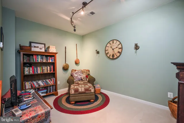 a living room with furniture and book shelf