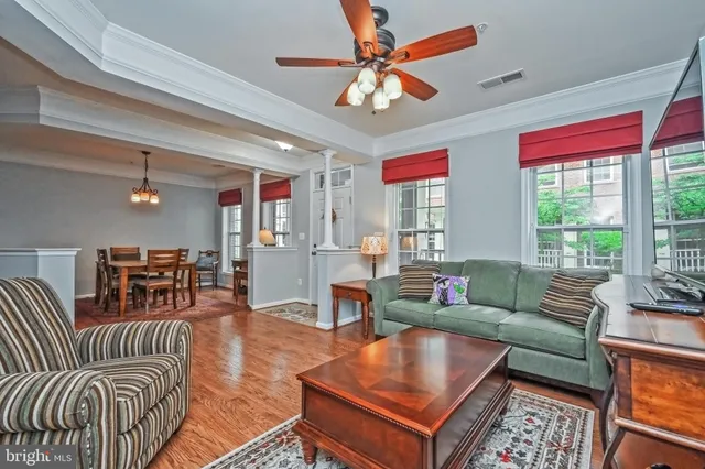 a living room with furniture a flat screen tv and a large window
