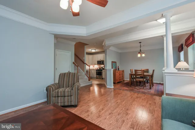 a living room with furniture and a dining table with kitchen view