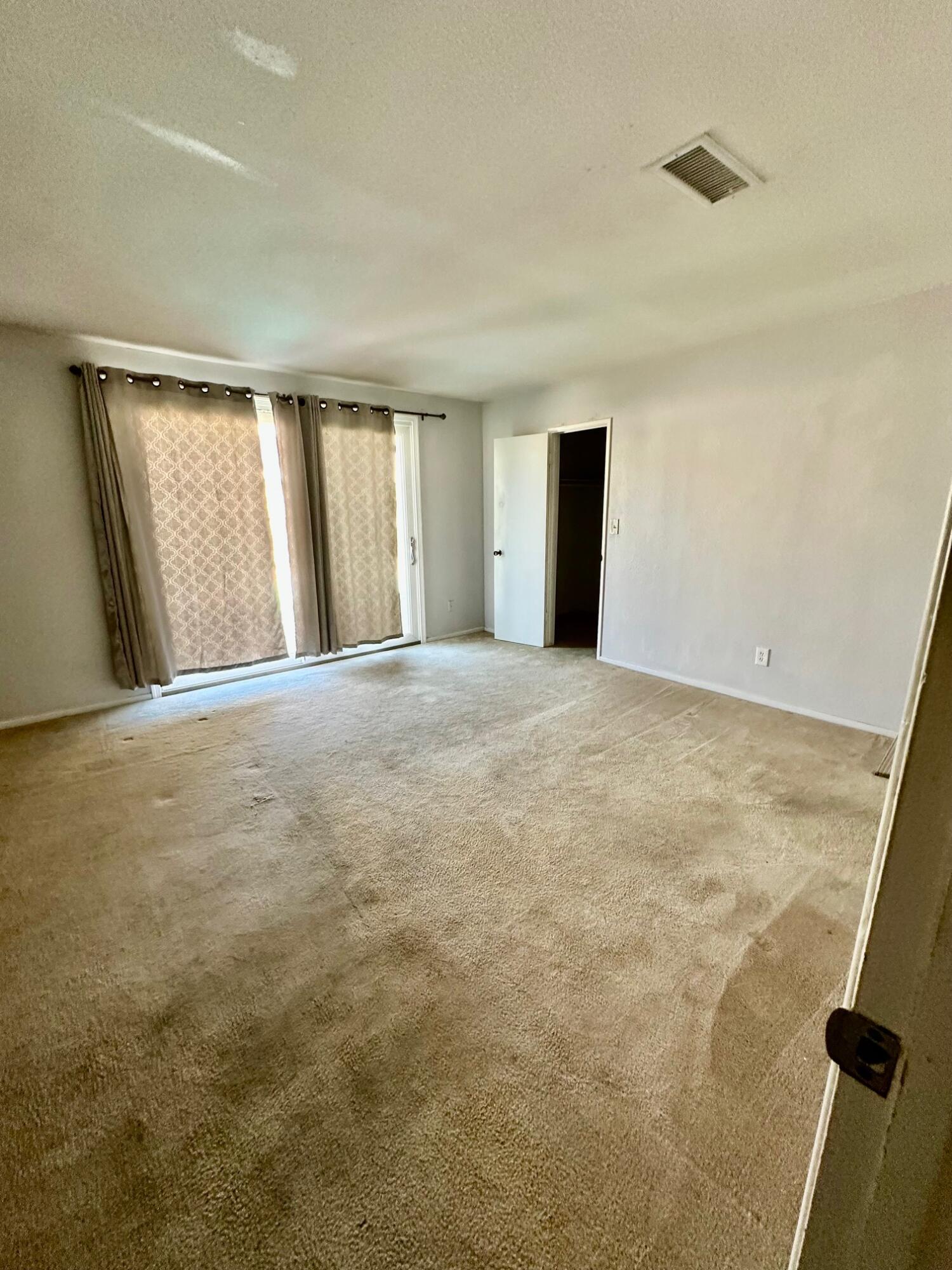 73100 Santa Rosa Way Palm Desert, CA 92260 - Photo 13 of 25 a view of an empty room with window and a kitchen