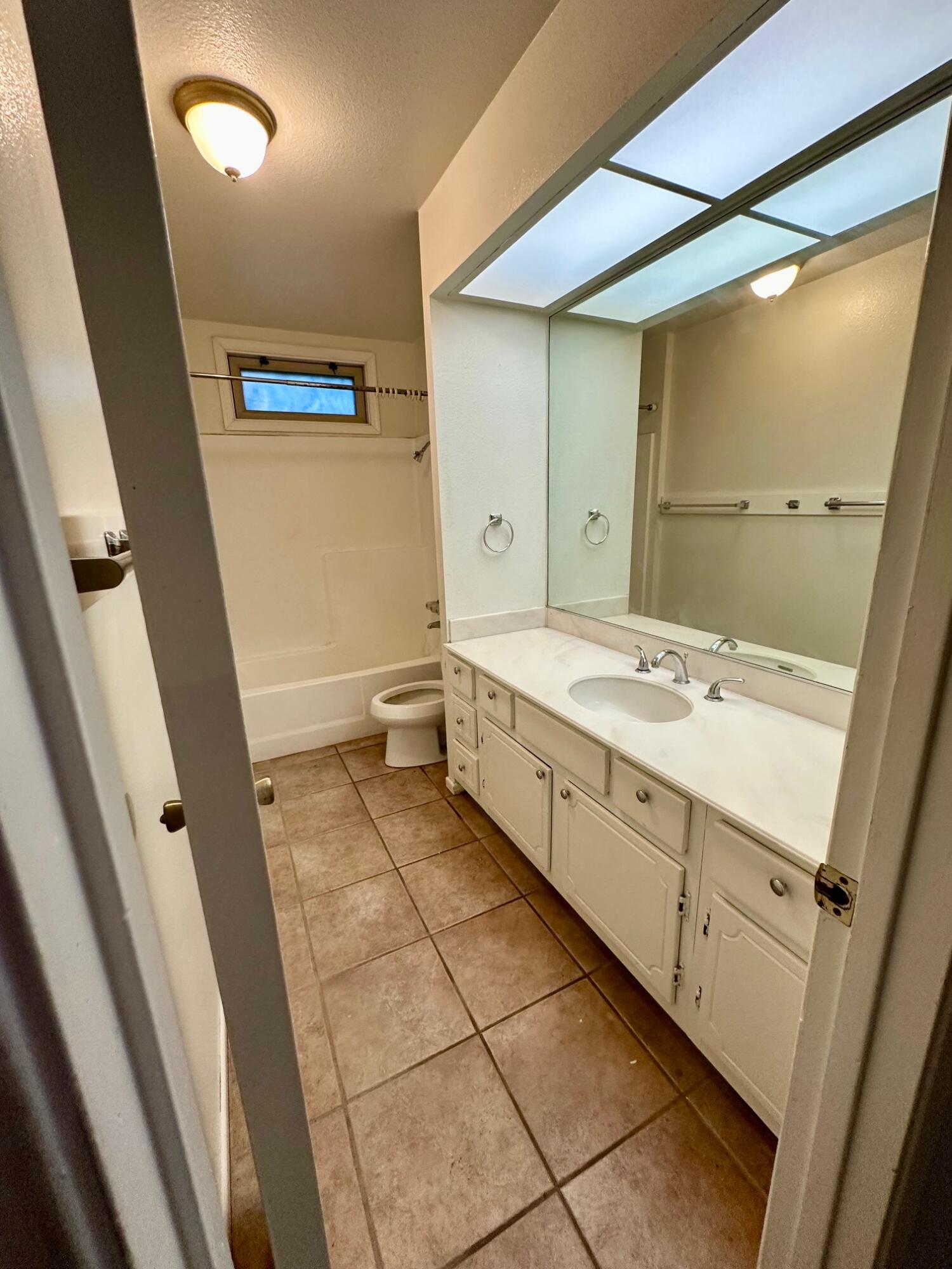 73100 Santa Rosa Way Palm Desert, CA 92260 - Photo 16 of 25 a bathroom with a double vanity sink and mirror with bathtub