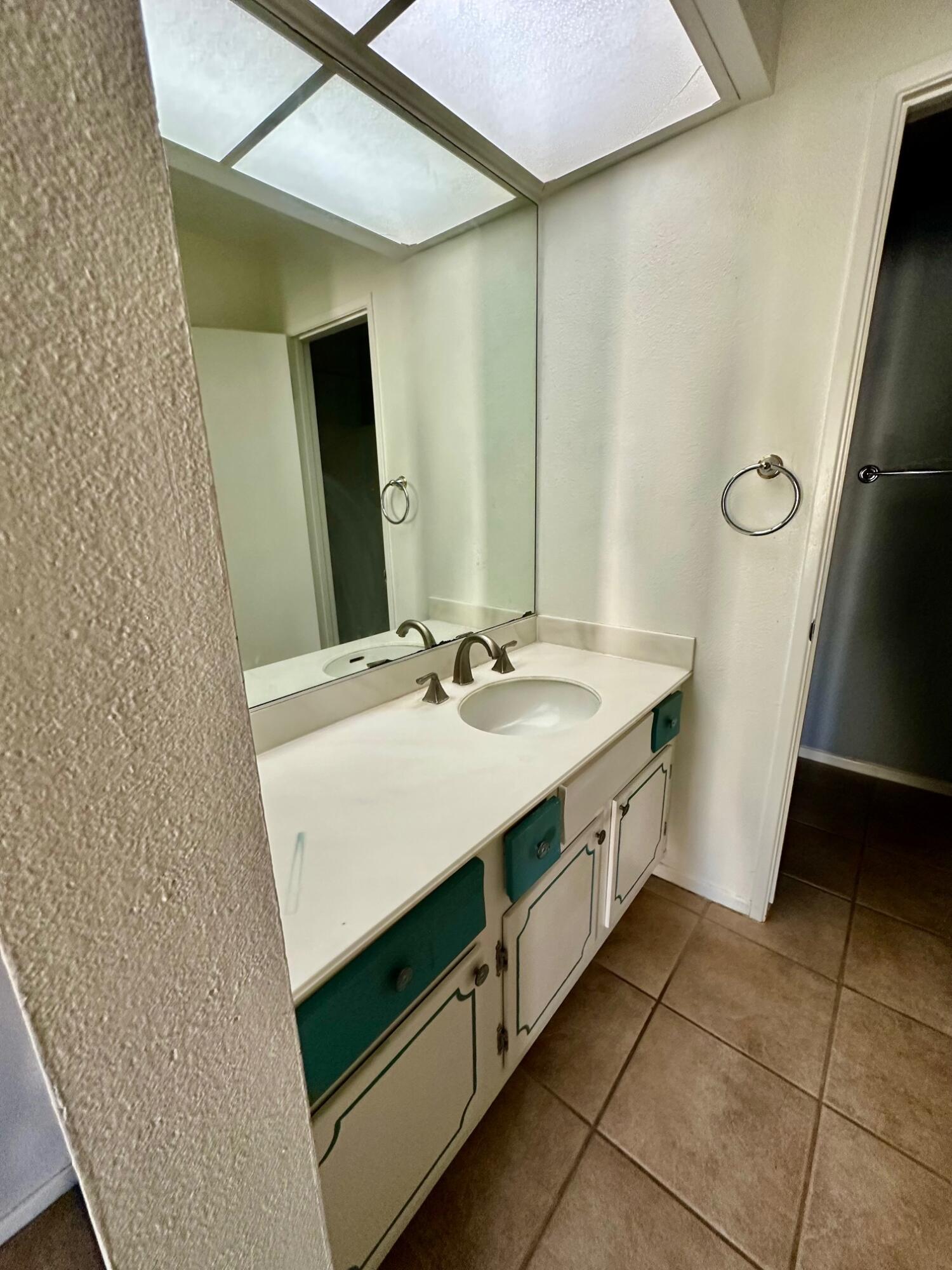 73100 Santa Rosa Way Palm Desert, CA 92260 - Photo 17 of 25 a bathroom with a sink a vanity and a mirror