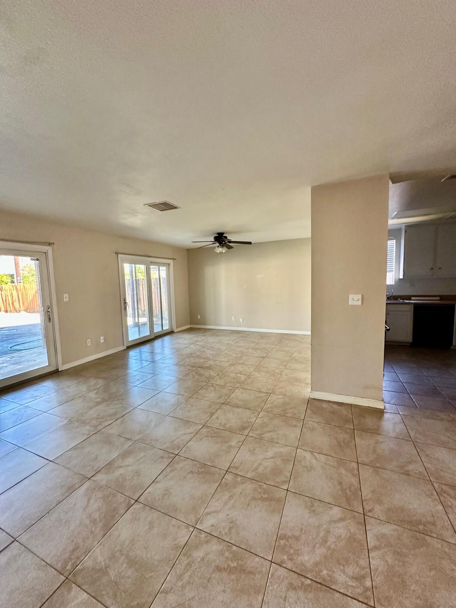 73100 Santa Rosa Way Palm Desert, CA 92260 - Photo 6 of 25 a view of empty room with kitchen and window