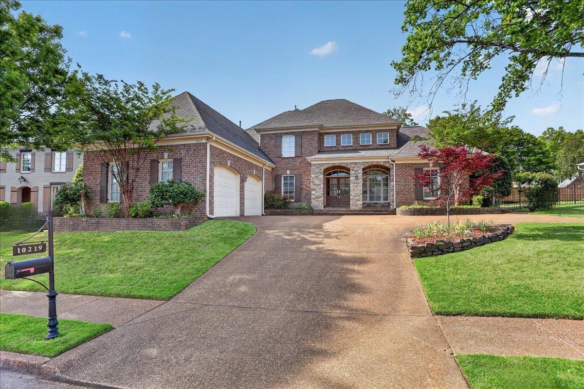 10219 Statfield Drive Collierville, TN 38017 - Photo 1 of 37 a front view of a house with a garden