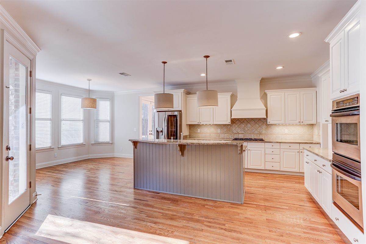 10219 Statfield Drive Collierville, TN 38017 - Photo 11 of 37 a large kitchen with stainless steel appliances kitchen island granite countertop a large counter top and wooden floors