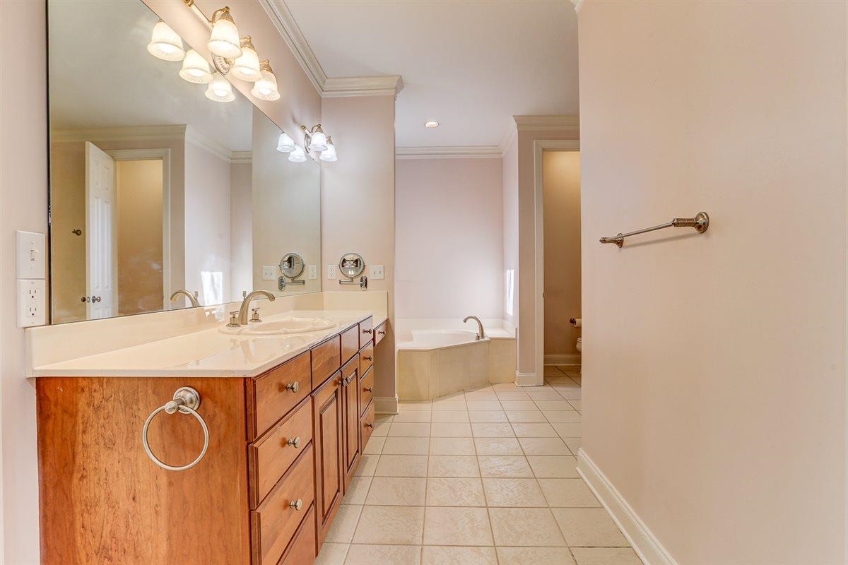 10219 Statfield Drive Collierville, TN 38017 - Photo 17 of 37 a spacious bathroom with a sink a mirror and a shower