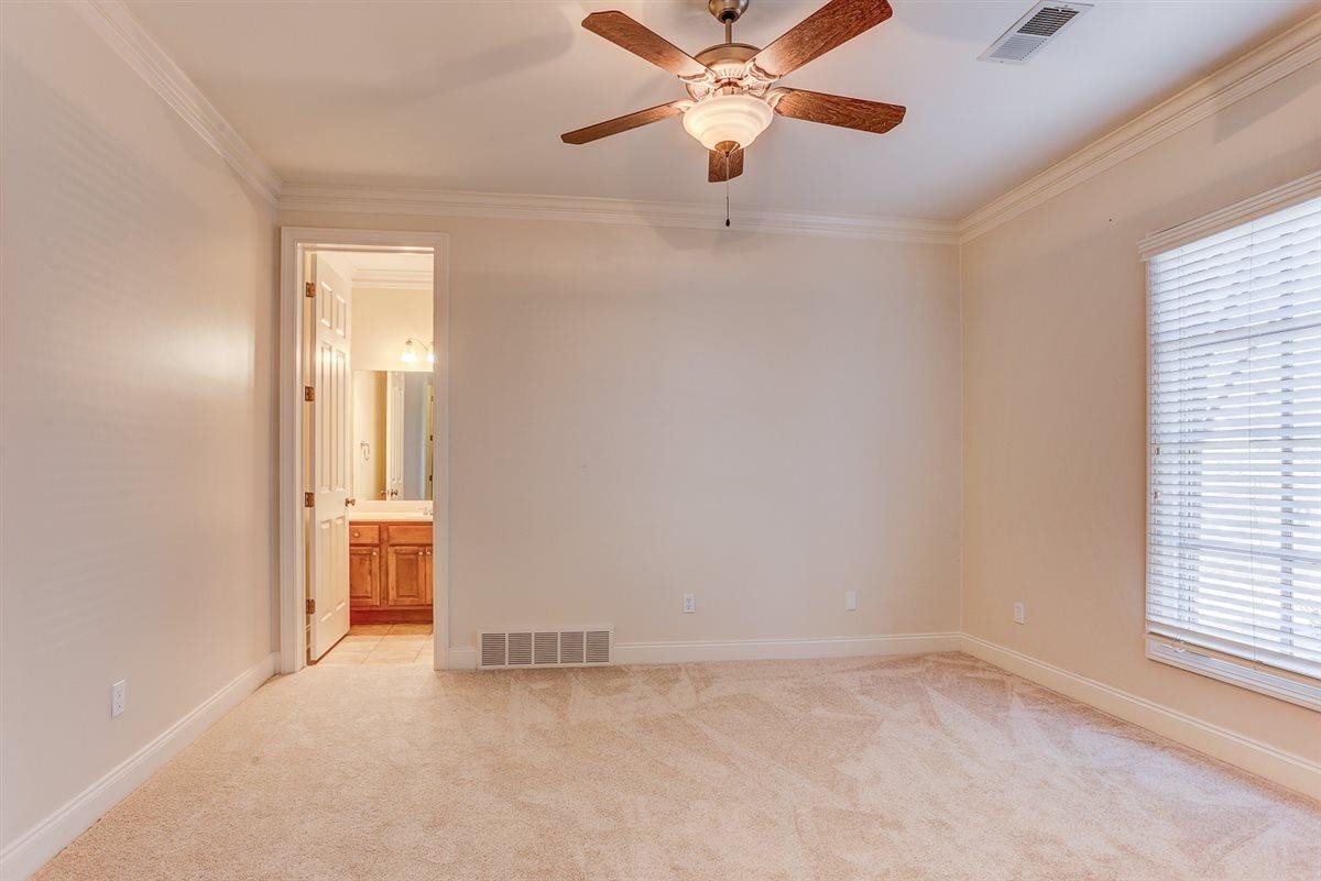 10219 Statfield Drive Collierville, TN 38017 - Photo 21 of 37 an empty room with chandelier fan and windows