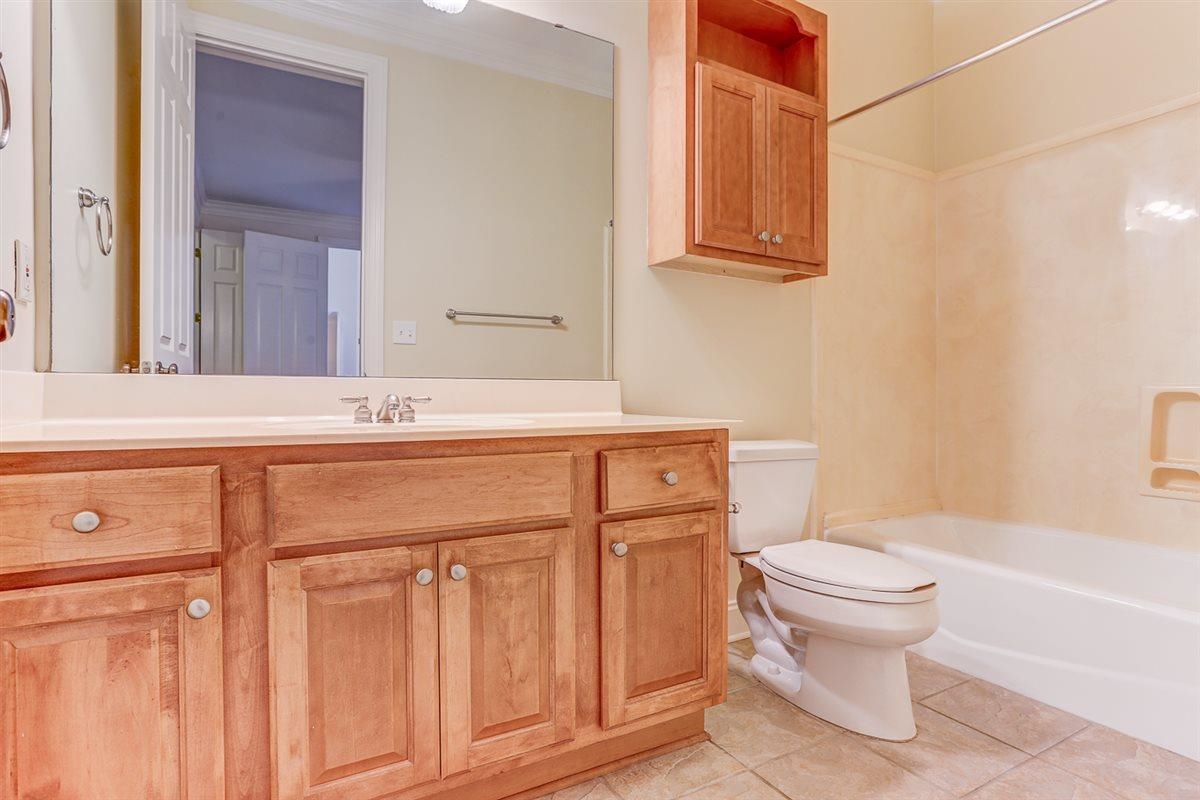 10219 Statfield Drive Collierville, TN 38017 - Photo 22 of 37 a bathroom with a sink a toilet and shower