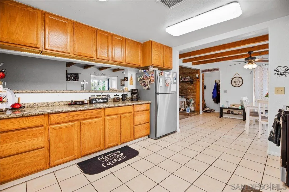 8719 Gardena Road Lakeside, CA 92040 - Photo 11 of 38 a kitchen with stainless steel appliances granite countertop a refrigerator and a stove top oven