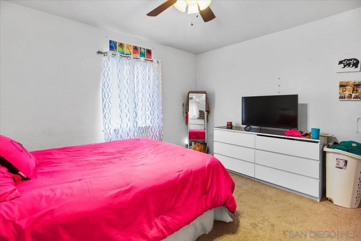 8719 Gardena Road Lakeside, CA 92040 - Photo 13 of 38 a bedroom with a bed and a flat screen tv