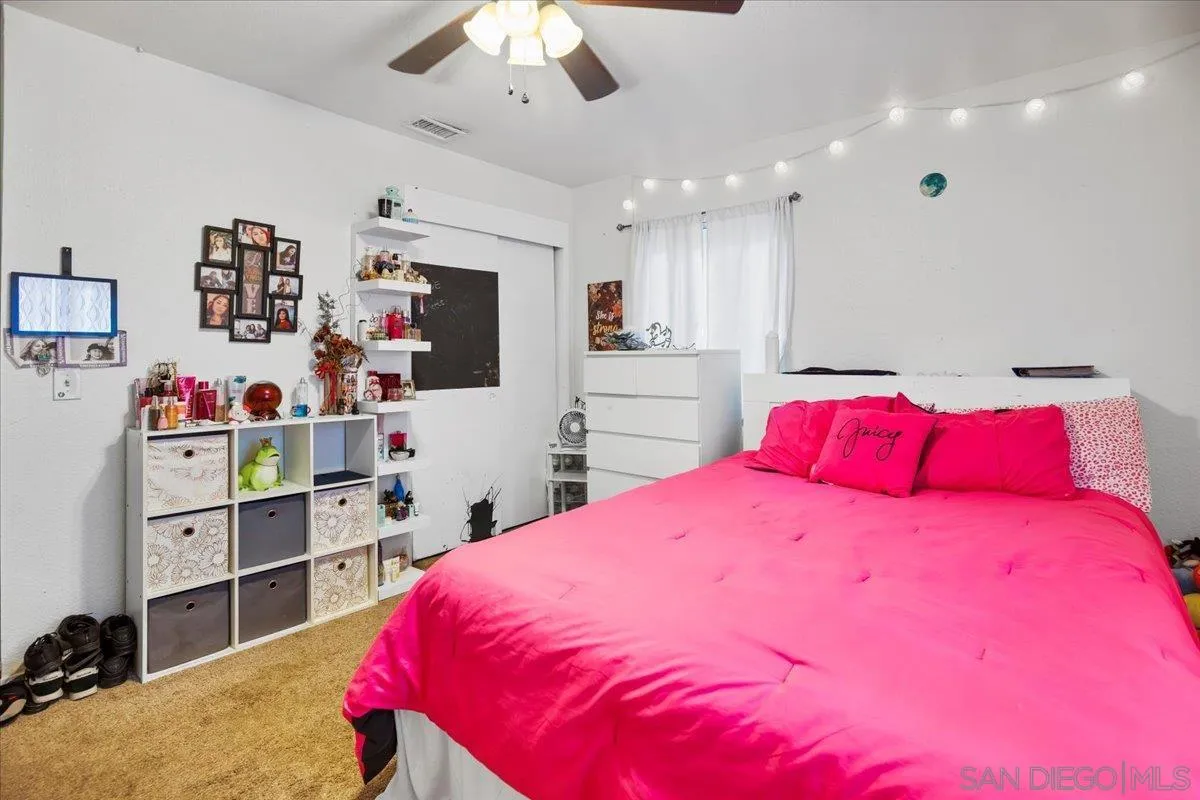 8719 Gardena Road Lakeside, CA 92040 - Photo 14 of 38 a bedroom with a bed and a chandelier
