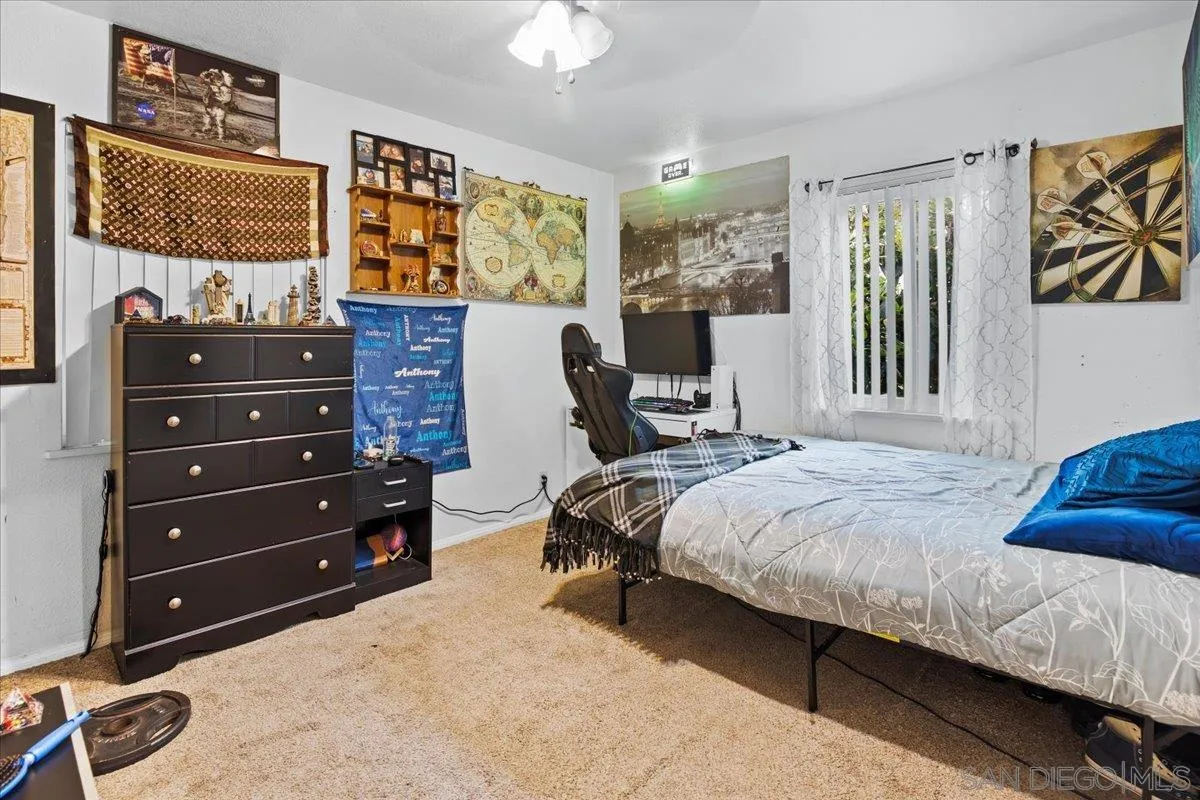 8719 Gardena Road Lakeside, CA 92040 - Photo 16 of 38 a bedroom with a bed and wooden floor