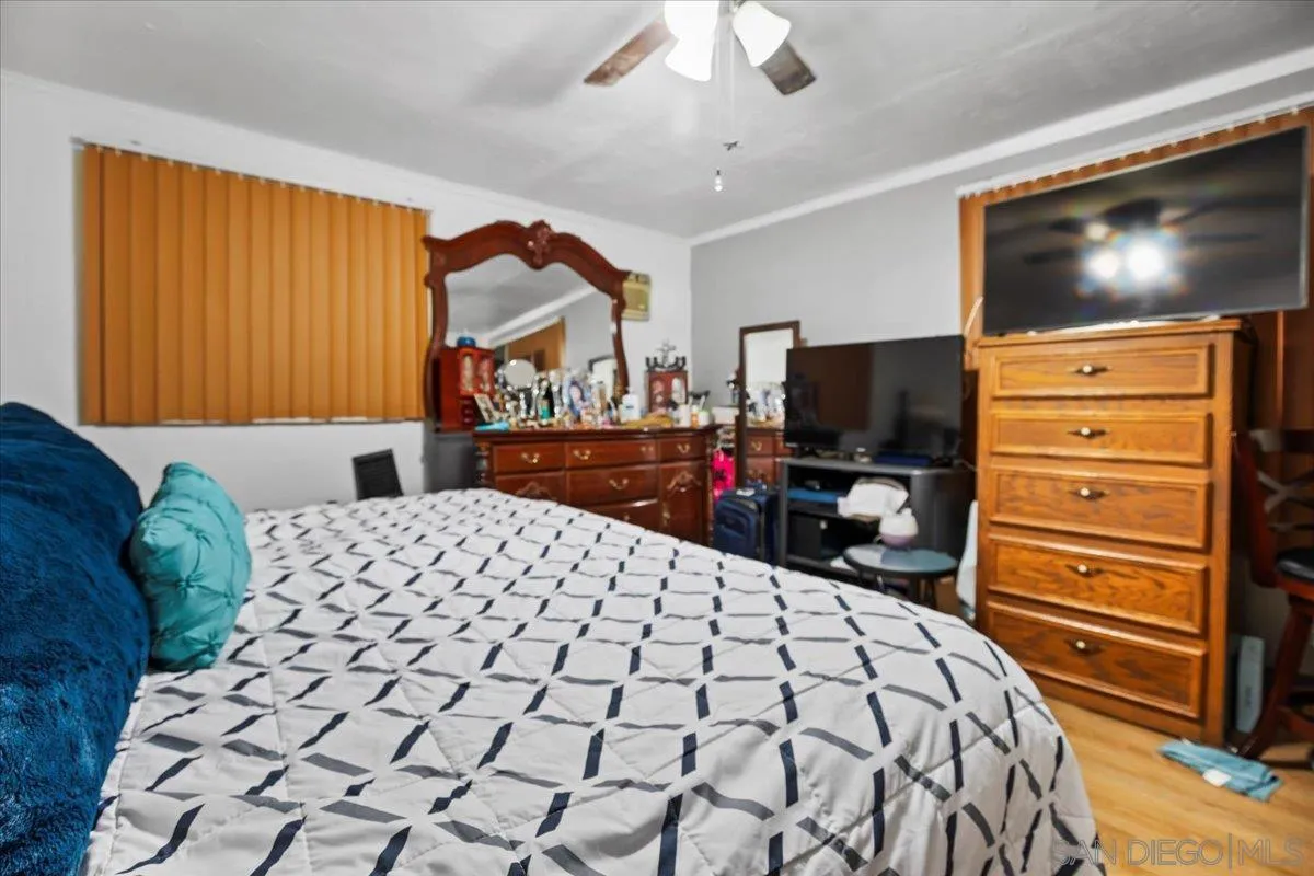 8719 Gardena Road Lakeside, CA 92040 - Photo 30 of 38 a bedroom with a bed and a flat screen tv